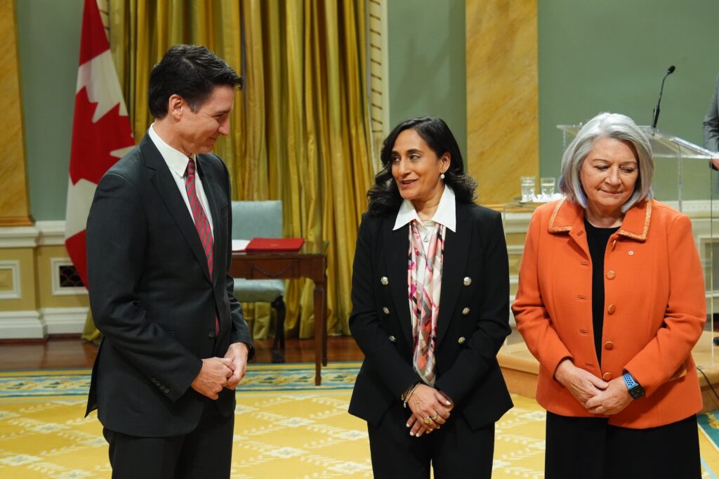 Prime Minister Justin Trudeau talks with Transport Minister Anita Anand beside Gov. Gen. Mary Simon during a cabinet swearing-in ceremony at Rideau Hall