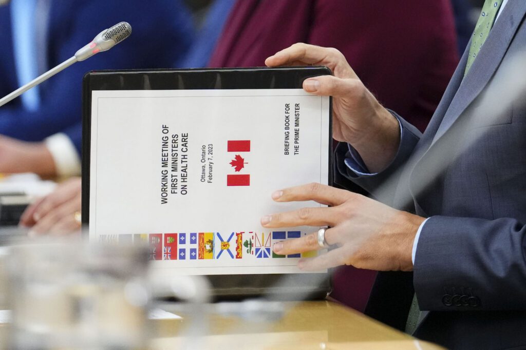 Prime Minister Justin Trudeau flips open a briefing book